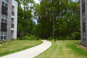 a walkway between two apartment buildings and a red fire hydrant